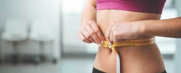 woman measuring stomach 1296x728