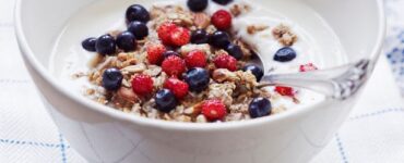 Bowl of yogurt with cereal and berries